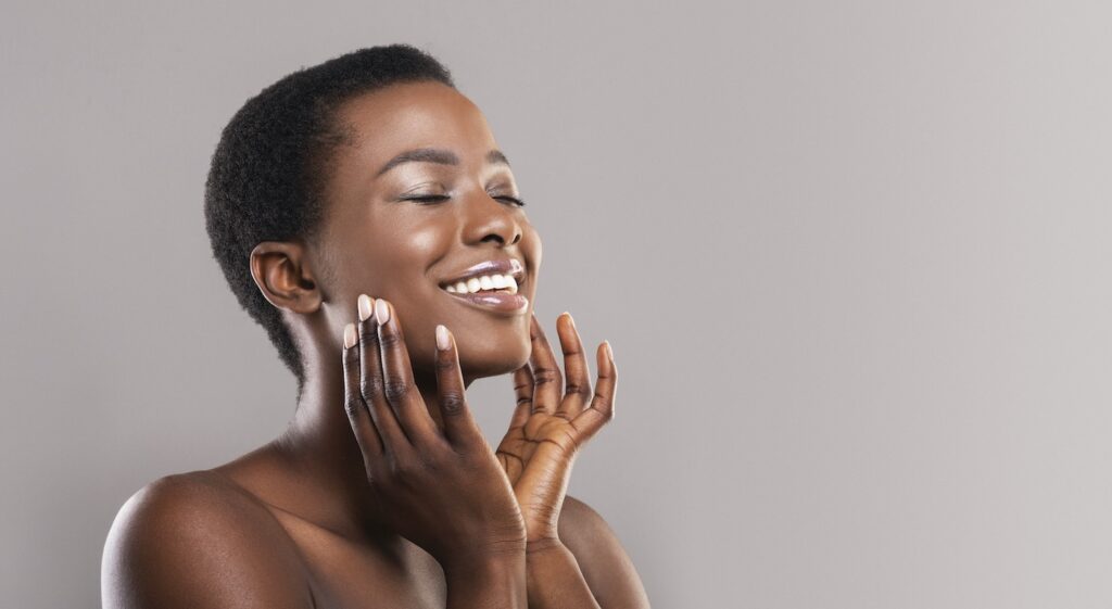 1739909408 happy afro woman touching soft smooth skin on her 9RG52DN 1739909408 happy afro woman touching soft smooth skin on her 9RG52DN