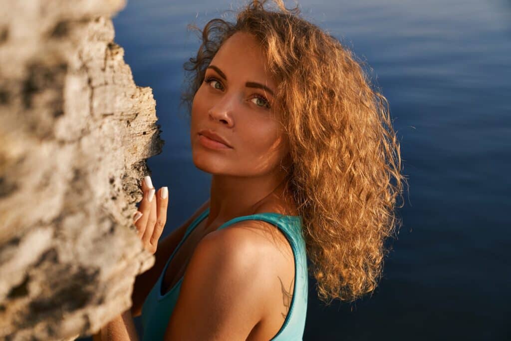 1739909928 romantic girl near rock on background of water W2QAMYL 1739909928 romantic girl near rock on background of water W2QAMYL