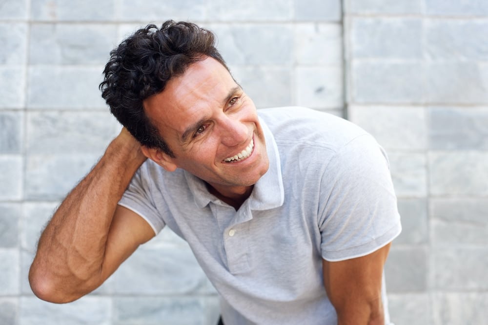 1739910012 handsome older man laughing with hand in hair PBUYH5T 1739910012 handsome older man laughing with hand in hair PBUYH5T