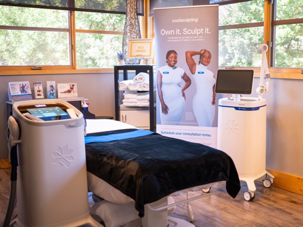 A clean, modern CoolSculpting treatment room at Premier Skin Clinic featuring a padded treatment bed between two CoolSculpting devices A clean, modern CoolSculpting treatment room at Premier Skin Clinic featuring a padded treatment bed between two CoolSculpting devices