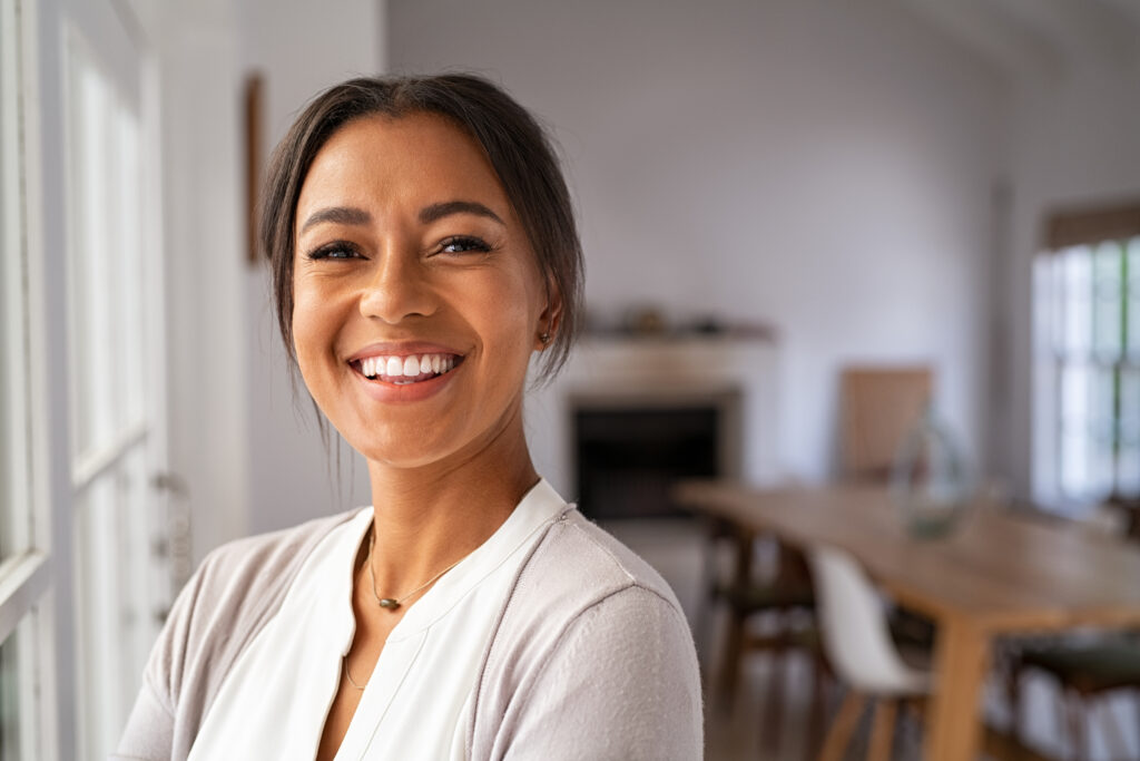 Happy mid woman looking at camera Beautiful middle aged woman tightens loose skin for improved appearance.